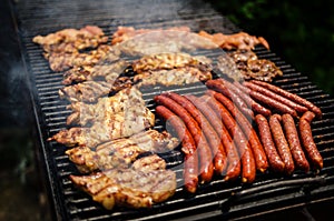 Sausages and meat on a grill