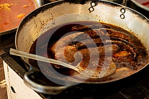 Sausages in an old frying pan in a market of Sucre, Bolivia