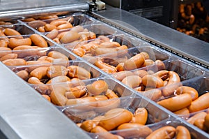 Sausages. Packing line of sausage. Industrial manufacture of sausage products.