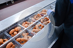 Sausages. Packing line of sausage. Industrial manufacture of sausage products.