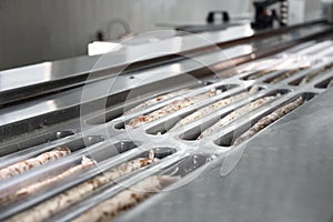 Sausages. Packing line of sausages. Industrial manufacture of sausage products.