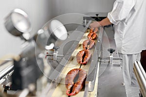 Sausages. Packing line of sausages. Industrial manufacture of sausage products.