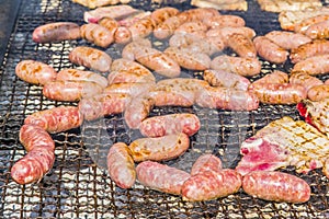 Sausages and pork steaks on the large barbeque