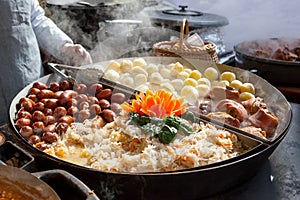 Sausages, potatoes, cabages and pork in big pan