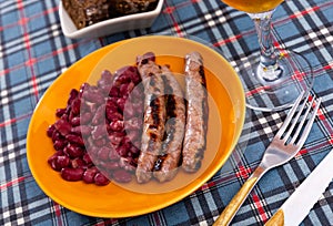 Sausages with red beans, typical Catalan dish butifarra con alubias photo