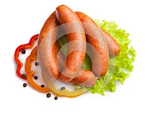 Sausages with salad and paprika on a white background.