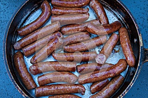 Sausages Sizzle While Cooking In Frying Pan