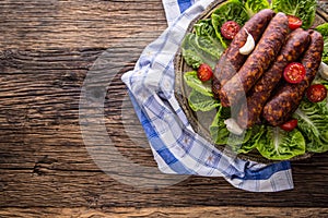 Sausages. Smoked Sausages. Chorizo sausages with vegetable rosemary spices and kitchen utensil