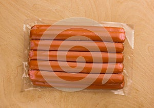 Sausages vacuum packed on a wooden surface.