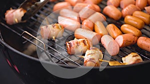 Sausages wrapped in bacon fried on the tray. Sausages wrapped in bacon barbecue