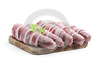 Sausages wrapped in bacon isolated on white