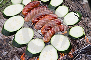 Sausages and zucchini  being barbequed