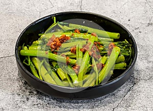 sauteed garlic spinach or rau muong xao toi served in dish isolated on grey background top view of singapore seafood