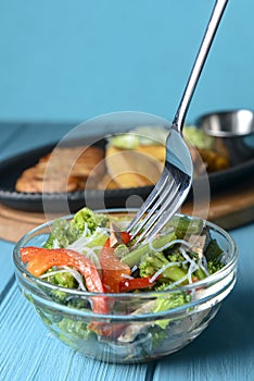 Sauteed vegetable salad with broccoli, asparagus, sweet pepper and cellophane noodles or fensi noodles in a glass bowl