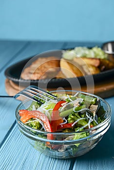 Sauteed vegetable salad with broccoli, asparagus, sweet pepper and cellophane noodles or fensi noodles in a glass bowl