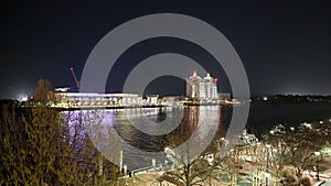 The Savannah Convention Center and the Westin Hotel along the Savannah River at night with lights and bare winter trees