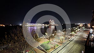 The Savannah Convention Center and the Westin Hotel along the Savannah River at night with lights and bare winter trees