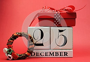 Save the Date for Christmas day with this white wooden blocks calendar for December 25, with a festive red present gift