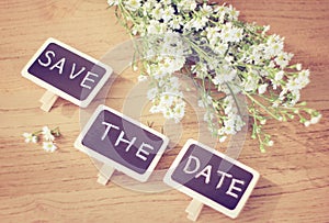 Save the date written on blackboard with flower