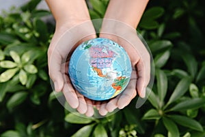 Save The Earth and Care Environment Concept, Close-up of Woman Hands is Holding Mockup Global Against on Tree Leave Background.