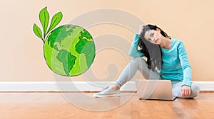 Save earth concept with woman using a laptop