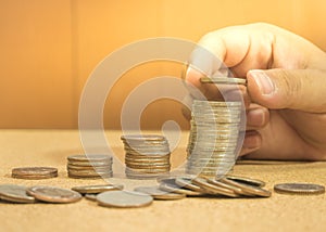 Save money concept preset by hand putting money coin stack gro photo