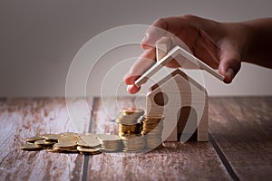 Save money concept, Property investment, house loan, reverse mortgage, gold coins money stack with on wooden table