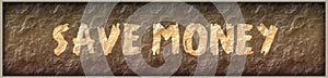 SAVE MONEY written with paint on rock panel background