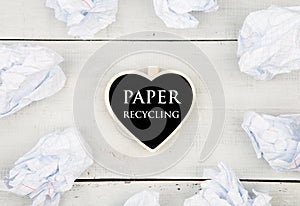 Save the planet concept - crumpled paper around a blackboard in shape of heart and text Paper recycling