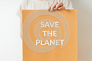 Save the planet - ecology sign of protest for green future of planet. woman holding paper