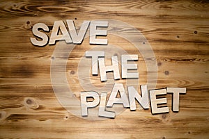SAVE THE PLANET words made of wooden block letters on wooden board