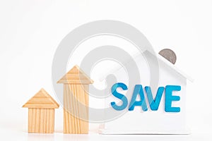 Save word on house is white Piggy bank with coins on white background.Time to invest, real estate and property concept. Finance