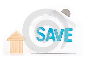 Save word on house is white Piggy bank with coins on white background.Time to invest, real estate and property concept. Finance