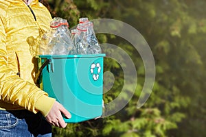 Save the world plastic free. Girl`s hands hold a box with empty plastic bottles.
