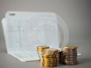 Saving account passbook , and stacks of coins