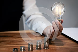 Saving coins idea with light bulb for investment Concept idea and innovation