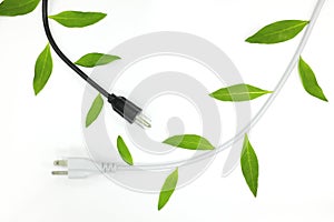 Saving electricity and green alternative energy concept. Electric plug cord with green leaves.