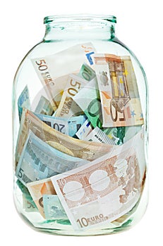 Saving euro money in glass jar