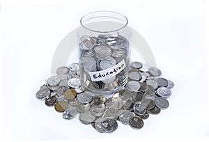 Saving idr coins in the glass bottle jar for education