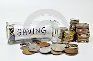 Saving lable in a glass jar with coins spilling out