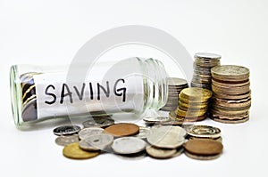 Saving lable in a glass jar with coins spilling out