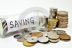 Saving lable in a glass jar with coins spilling out