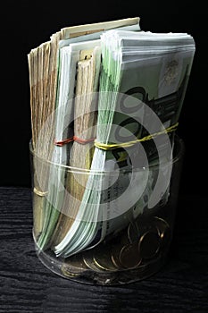 Saving money box with euro banknotes, cents. Banknotes of the european union. Euro cash background.
