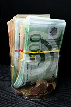 Saving money box with euro banknotes, cents. Banknotes of the european union. Euro cash background.