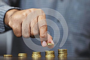 Saving money. businessman hand putting stack coins to show concept of growing savings money finance business