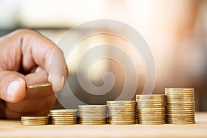 Saving money. businessman hand putting stack coins to show concept of growing savings money finance business and wealthy.