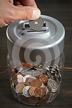 Saving money in a coin jar photo