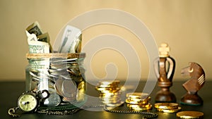 Saving money coin in jar. Symbol of investing, keeping money concept. Collecting cash banknotes in glass tin as moneybox