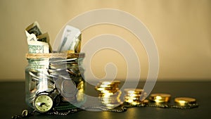 Saving money coin in jar. Symbol of investing, keeping money concept. Collecting cash banknotes in glass tin as moneybox