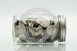 Saving money concept of collecting coins Thai money in a glass bottle on isolate white background. as background business conce